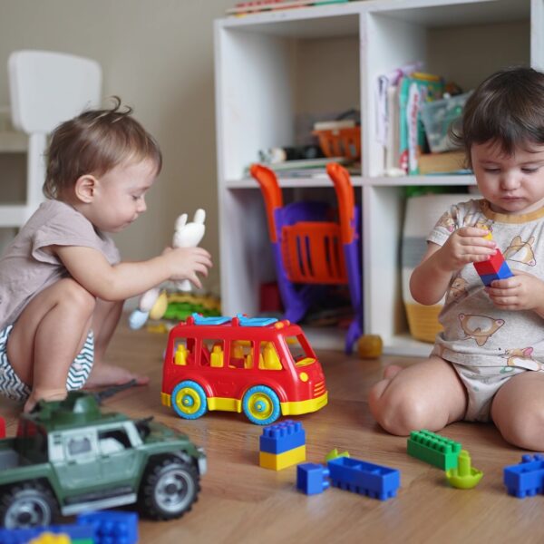 Baby,Group,Children,Playing,Toys,On,Floor,In,Kindergarten.,Happy