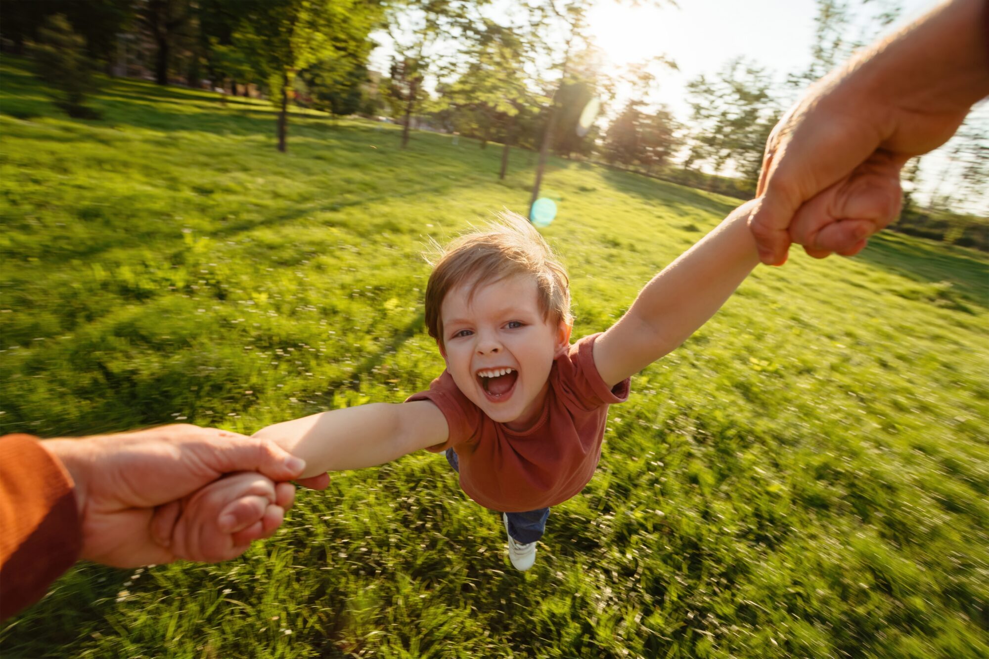 First person,View,,Father,Holding,His,Son's,Hands,,Spinning,Him,Around